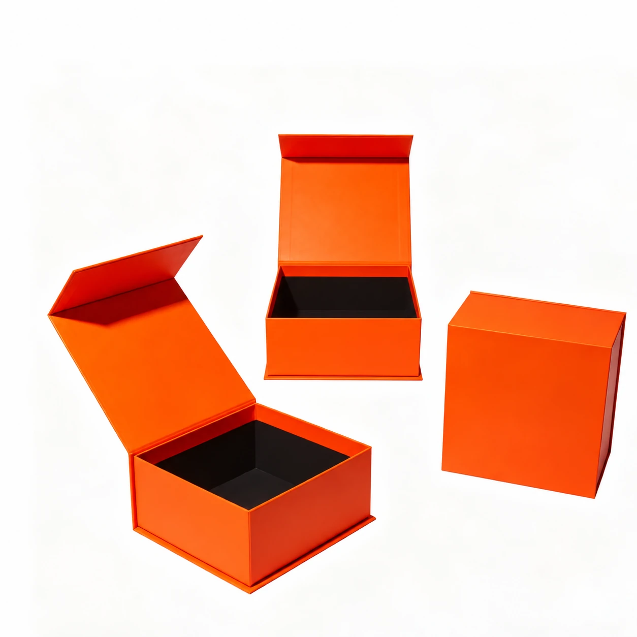 Orange wraparound book-style boxes shown closed and open with dark inner trays